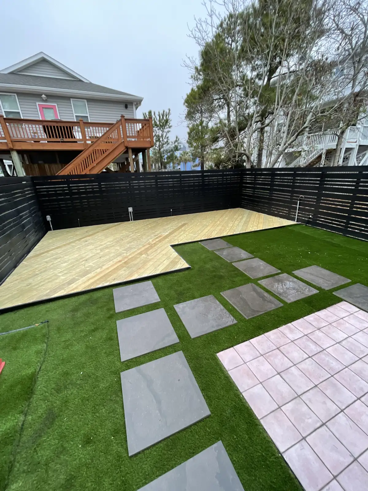 Custom composite deck with pergola and outdoor living space in coastal NC