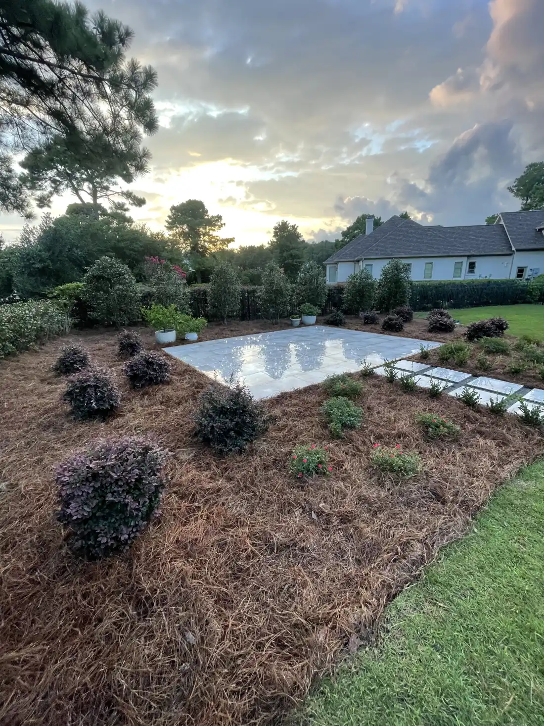 Curated landscape planting beds with hardscape integration in Wilmington NC