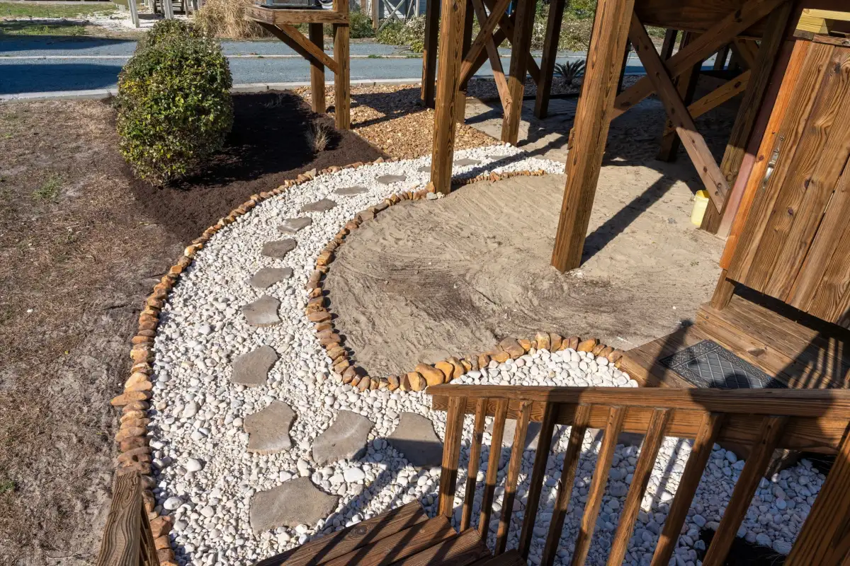 Koi pond with stone surround and curated plantings in Wilmington NC landscape