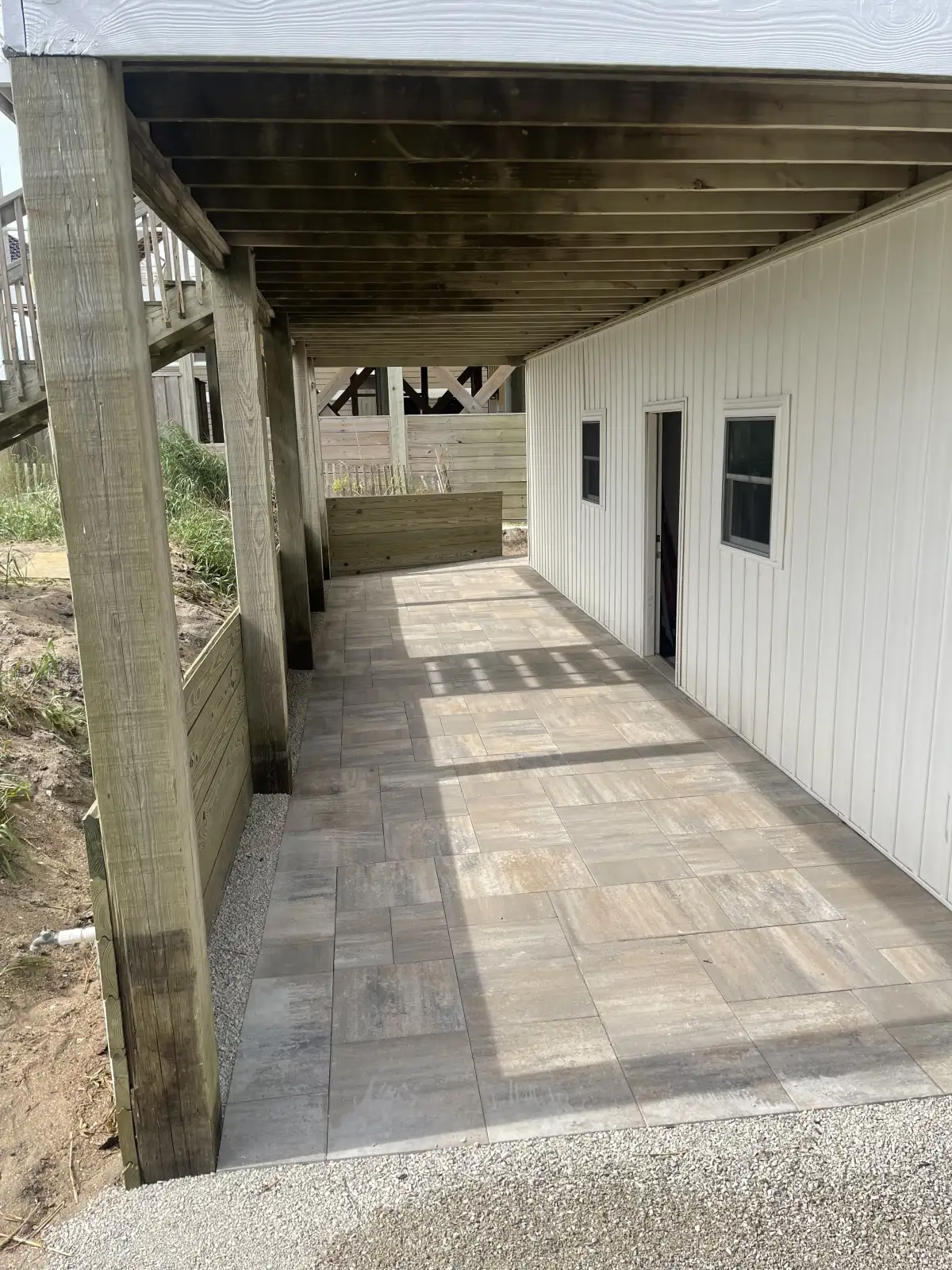 Outdoor kitchen built-in grill station with stone countertops in coastal NC luxury home