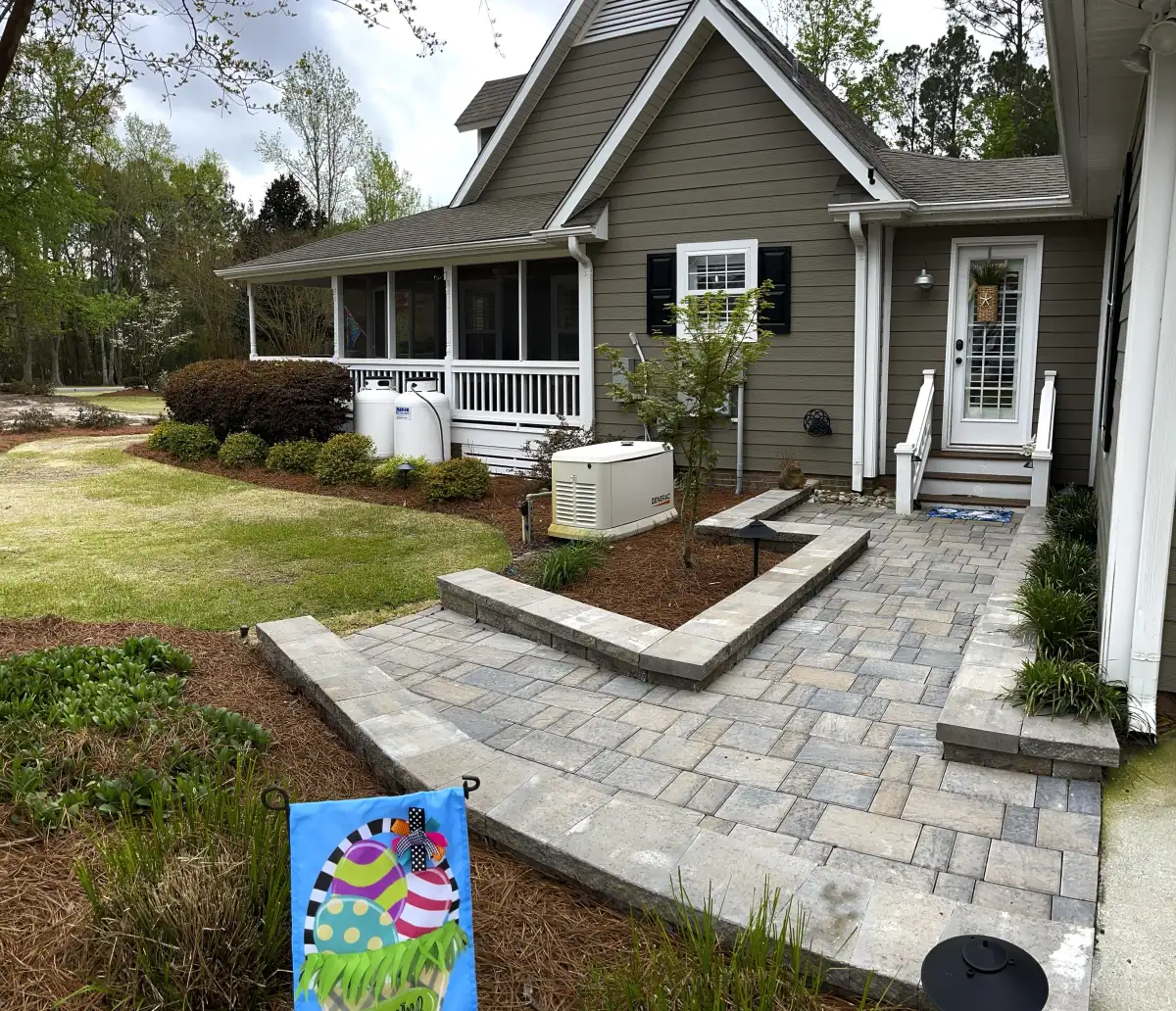 Luxury outdoor fireplace with stone mantle in Wilmington NC backyard