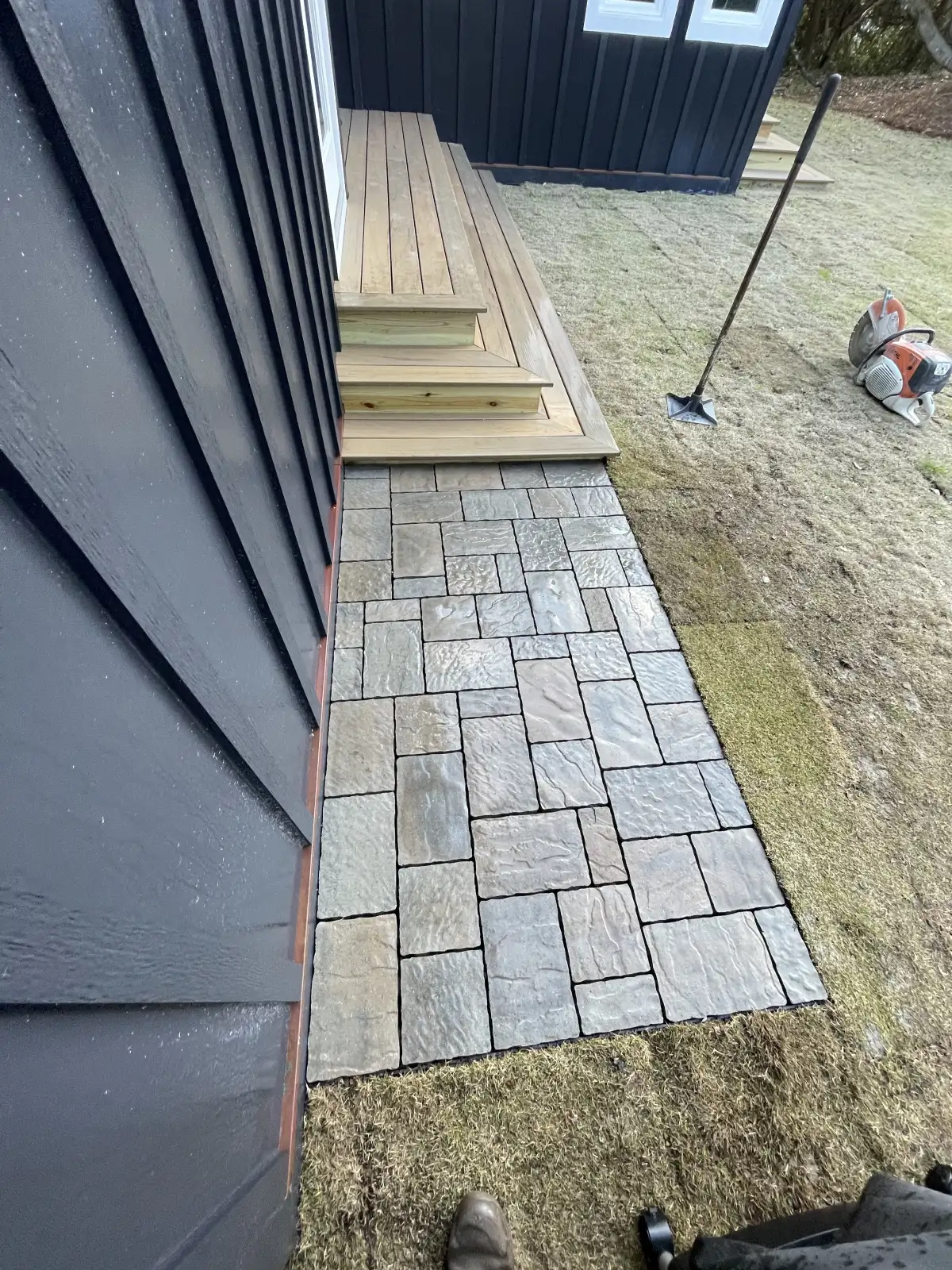 Multi-level paver patio with steps and seating wall in coastal North Carolina