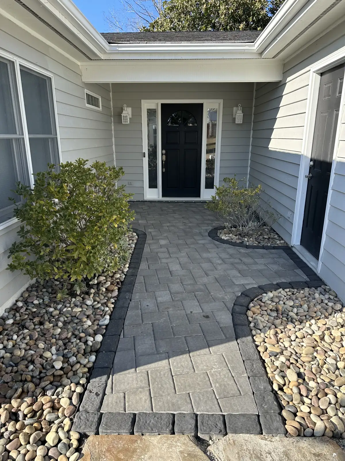 Paver patio with curved edge and outdoor seating area in coastal NC