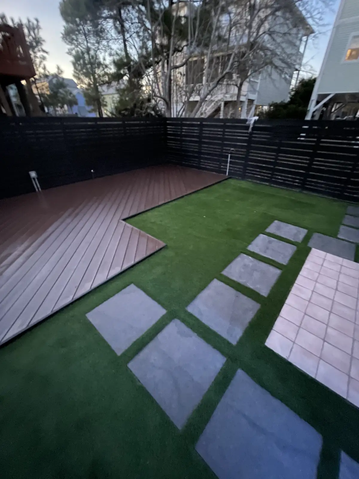 Detailed paver patio installation with border and fire pit surround