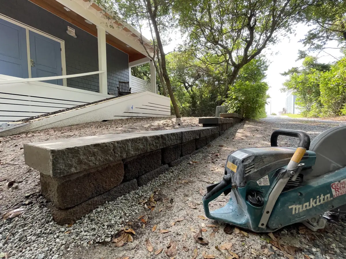 French drain installation with crushed stone in Wilmington NC yard